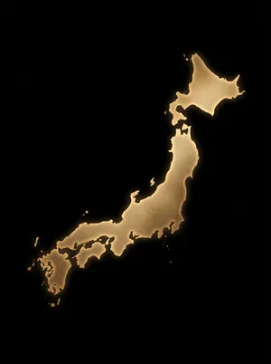 Glowing golden silhouette of Japan map