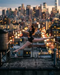 Dancer leaping over city at sunset