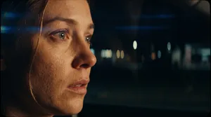 Woman driving at night with concern