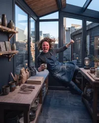 Artist levitating in furious pottery studio