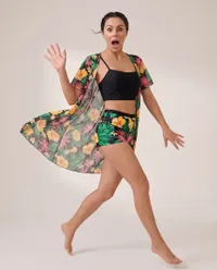 Surprised woman jumping in tropical swimwear