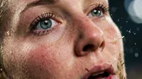Athletic woman intense closeup rain portrait