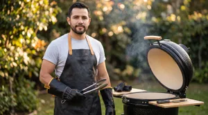 Man grilling with kamado charcoal smoker