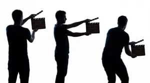 Three silhouettes holding clapperboards