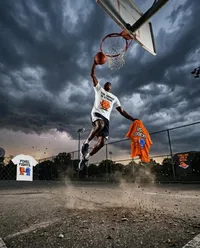 Athletic dunk mid-air storm court