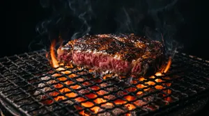 High quality marbled steak grilling on charcoal