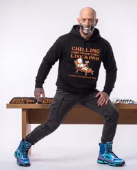 Cybernetic man poses with merch collection