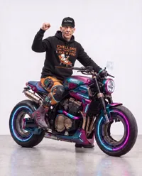 J.K. Simmons posing with cyber motorcycle