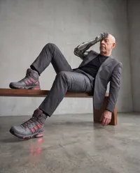 Cyborg business man sitting in studio