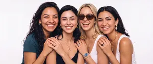 Group of four women laughing together