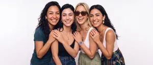 Group of four women laughing together
