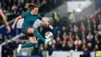 Intense female soccer player mid-air strike