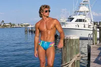 Sun-drenched athletic male at harbor